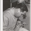 FSA (Farm Security Administration) dentist and migrant child in the FSA dental trailer at the FSA camp for farm families, Caldwell, Idaho