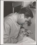 FSA (Farm Security Administration) dentist and migrant child in the FSA dental trailer at the FSA camp for farm families, Caldwell, Idaho