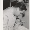 FSA (Farm Security Administration) dentist and migrant child in the FSA dental trailer at the FSA camp for farm families, Caldwell, Idaho