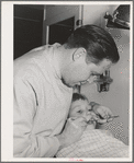 FSA (Farm Security Administration) dentist and migrant child in the FSA dental trailer at the FSA camp for farm families, Caldwell, Idaho