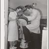 FSA (Farm Security Administration) dentist and nurse with migrant child in the FSA dental trailer at the FSA camp for farm families. Caldwell, Idaho