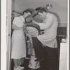 FSA (Farm Security Administration) dentist and nurse with migrant child in the FSA dental trailer at the FSA camp for farm families. Caldwell, Idaho