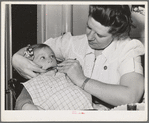 FSA (Farm Security Administration) nurse examines the teeth of migrant in the FSA dental trailer at the FSA camp for farm workers. Caldwell, Idaho