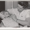 FSA (Farm Security Administration) nurse examines the teeth of migrant in the FSA dental trailer at the FSA camp for farm workers. Caldwell, Idaho