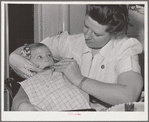 FSA (Farm Security Administration) nurse examines the teeth of migrant in the FSA dental trailer at the FSA camp for farm workers. Caldwell, Idaho