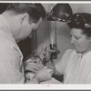 FSA (Farm Security Administration) dentist and nurse and migrant child in the FSA dental trailer at the FSA camp for farm families. Caldwell, Idaho