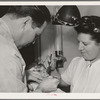 FSA (Farm Security Administration) dentist and nurse and migrant child in the FSA dental trailer at the FSA camp for farm families. Caldwell, Idaho