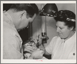 FSA (Farm Security Administration) dentist and nurse and migrant child in the FSA dental trailer at the FSA camp for farm families. Caldwell, Idaho