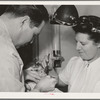 FSA (Farm Security Administration) dentist and nurse and migrant child in the FSA dental trailer at the FSA camp for farm families. Caldwell, Idaho