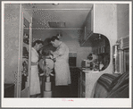 FSA (Farm Security Administration) dentist and nurse and migrant child in the FSA dental trailer at the FSA camp for farm families. Caldwell, Idaho