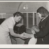 Two migrant children register with the nurse in the FSA (Farm Security Administration) dental trailer while it is parked at the FSA camp for farm families. Caldwell, Idaho