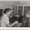 The FSA (Farm Security Administration) nurse types out dental record of migrant child in the dental trailer while at the FSA camp for farm workers. Caldwell, Idaho