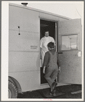 The FSA (Farm Security Administration) nurse welcomes migrant boy to FSA dental trailer at the FSA camp for farm families. Caldwell, Idaho