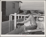 Carpenter at work on house of farmer on Black Canyon Project. Canyon County, Idaho