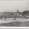 Children at play at the FSA (Farm Security Administration) camp for farm families. Caldwell, Idaho