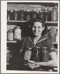 Mrs. Lee Wagoner with home canned fruits and vegetables. She and her husband farm on the Black Canyon Project. Canyon County, Idaho