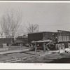 Unloading equipment from the FSA (Farm Security Administration) mobile camps at the permanent camp at Caldwell, Idaho