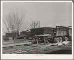 Unloading equipment from the FSA (Farm Security Administration) mobile camps at the permanent camp at Caldwell, Idaho