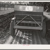Salinas, California. Intercontinental Rubber Producers. Guayule planter. Seeds mixed with sawdust are planted by this machine which also distributes a thin stream of sand over the seeds. This is a nursery operation. Seedlings sprout in a few days, grow in