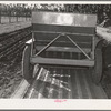 Salinas, California. Intercontinental Rubber Producers. Guayule planter. Seeds mixed with sawdust are planted by this machine which also distributes a thin stream of sand over the seeds. This is a nursery operation. Seedlings sprout in a few days, grow in