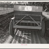 Salinas, California. Intercontinental Rubber Producers. Guayule planter. Seeds mixed with sawdust are planted by this machine which also distributes a thin stream of sand over the seeds. This is a nursery operation. Seedlings sprout in a few days, grow in