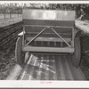Salinas, California. Intercontinental Rubber Producers. Guayule planter. Seeds mixed with sawdust are planted by this machine which also distributes a thin stream of sand over the seeds. This is a nursery operation. Seedlings sprout in a few days, grow in
