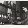 Salinas, California. Head chemist at the Intercontinental Rubber Producers experimenting on the deresination of guayule rubber