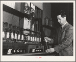 Salinas, California. Head chemist at the Intercontinental Rubber Producers experimenting on the deresination of guayule rubber