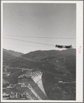 Shasta Dam under construction. The many cables are for transporting materials. Shasta County, California