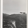 Shasta Dam under construction. The many cables are for transporting materials. Shasta County, California