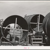 Segments of penstock pipe which will be used to transport water from reservoir formed by Shasta Dam to hydroelectric turbines. Notice the worker on top pipe; he is welding segments together. Shasta County, California