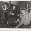 This workman controls amounts of materials going into concrete used in construction of Shasta Dam. Shasta County, California