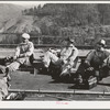 Workers on Pit River bridge eat lunch. Shasta County, California