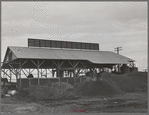 A byproducts plant in olive oil industry. The mounds are the pomace left after "soap" oil is extracted. This pomace has some value as a fertilizer. Strathmore, California