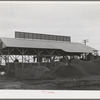 A byproducts plant in olive oil industry. The mounds are the pomace left after "soap" oil is extracted. This pomace has some value as a fertilizer. Strathmore, California