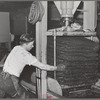 Hydraulic pressure is applied to bags of crushed olives to force out the oil. The first pressing extracts about seventy-five percent of the entire oil content. This is fine virgin olive oil. Lindsay, California