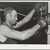 Lindsay, California. The pressure of the olive press must be carefully watched, for different degrees of pressure are prescribed for the two pressings. The first yields the virgin oil, about twenty-five percent of the total oil content of the olives;