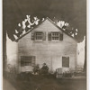 Walter Huston and Mary Morris seated with full set behind, including house, in the stage production Desire Under the Elms