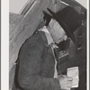 Imperial County, California. Cattleman notes down number of head of cattle shipped