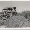 Bulldozer works on irrigation ditch. Imperial County, California