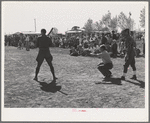 Boys from nearby Army camp play baseball at the field day at the FSA (Farm Security Administration) farm workers' community. Yuma, Arizona