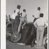 Farm workers watch athletic events at the second annual field day at the FSA (Farm Security Administration) farm workers' community. Yuma, Arizona