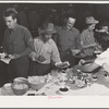 Farm workers at dinner at the second annual field day at the FSA (Farm Security Administration) farm workers' community. Yuma, Arizona