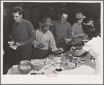 Farm workers at dinner at the second annual field day at the FSA (Farm Security Administration) farm workers' community. Yuma, Arizona