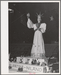 Exhibit at the Imperial County Fair, California. The words at the base of statue are "Vitamins for Victory." Notice the plowshares on corners of exhibit