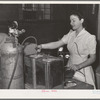 Putting inert gas into cans of dehydrated cabbage which will be hermetically sealed