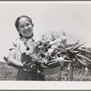 Marileeann Simpson holds a pan of vegetables freshly gathered from her family's garden at the FSA (Farm Security Administration) farm workers community. Yuba City, California