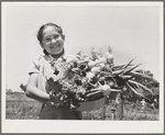 Marileeann Simpson holds a pan of vegetables freshly gathered from her family's garden at the FSA (Farm Security Administration) farm workers community. Yuba City, California