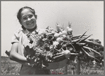 Marileeann Simpson holds a pan of vegetables freshly gathered from her family's garden at the FSA (Farm Security Administration) farm workers community. Yuba City, California
