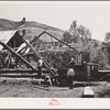 Ola, Idaho. FSA (Farm Security Administration) Ola self-help cooperative. A member places a hook on a log